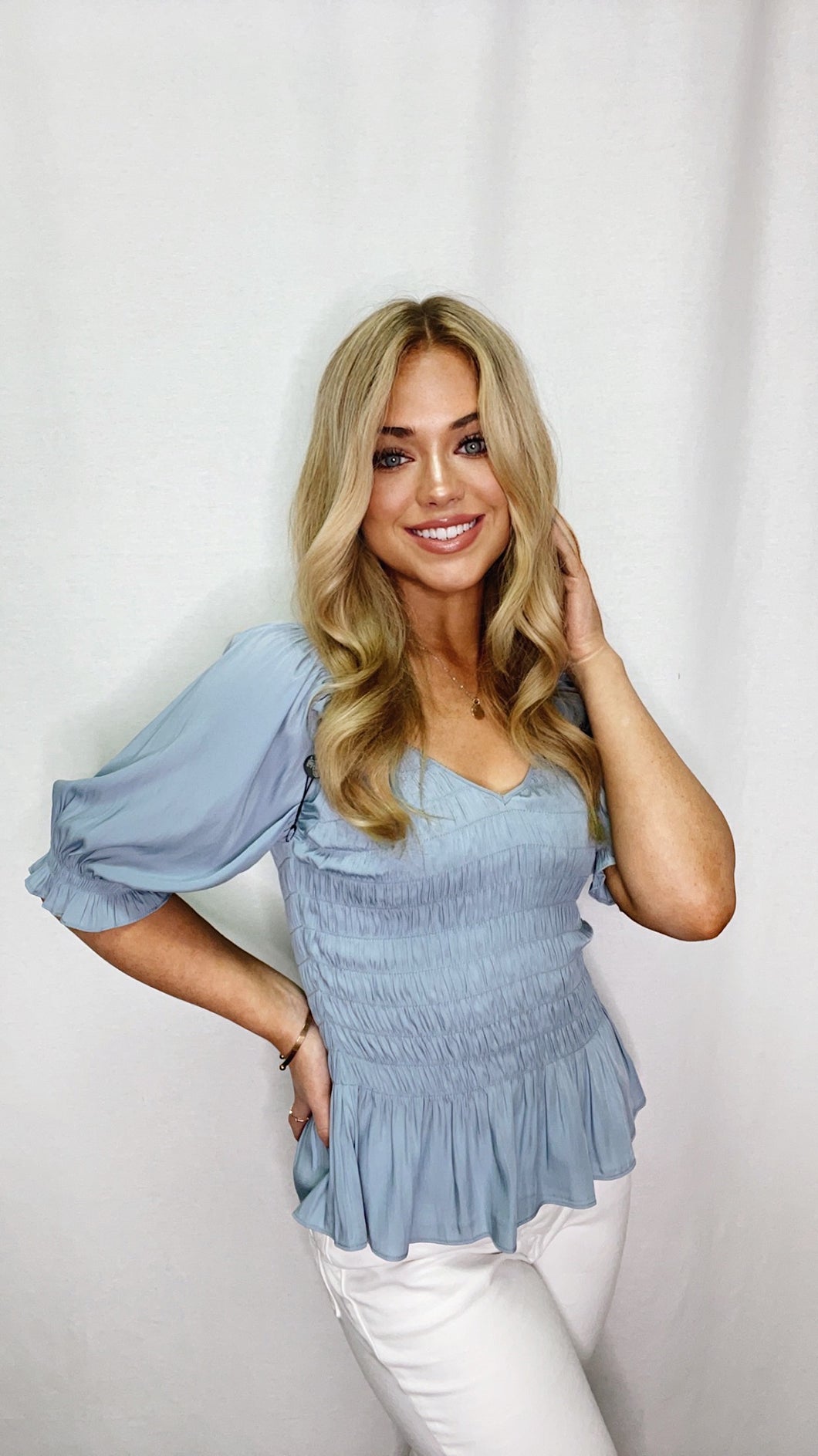 Smocked V-Neck Top from Lola & Sophie: a chic addition to your wardrobe with flattering V-neckline and smocked details.