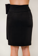 Load image into Gallery viewer, A woman wearing a black skirt with a bow, showcasing the elegant Black Bow Waist Skirt from Posh Couture.
